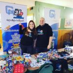 January at Creatos Media: Izzy and Filip stand proudly at their sponsorship booth during the Great Orchestra of Christmas Charity event in Birmingham, showcasing their commitment to social causes and community involvement.